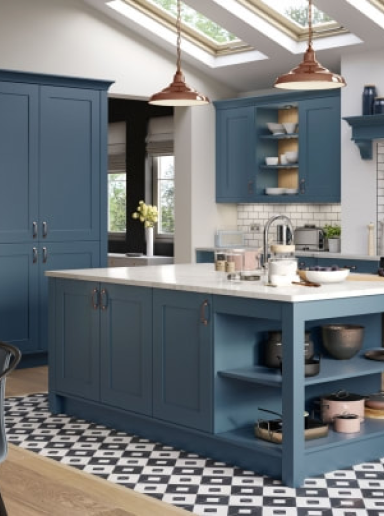 Bright modern kitchen with blue island and cupboards, illuminated by skylights.