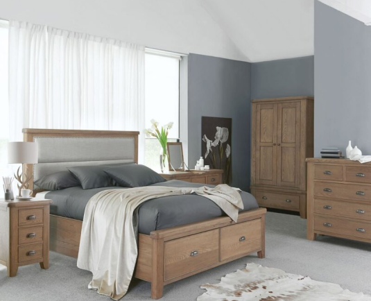 Modern bedroom with a wooden bedframe, matching cabinets, and coordinated bedside furniture.